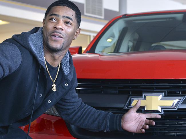 New England Patriots cornerback Malcolm Butler poses with a Chevrolet pickup truck he was presented Tuesday, Feb. 10, 2015, at a dealership in Norwood, Mass. The truck was intended to go to Patriots quarterback Tom Brady as Super Bowl Most Valuable Player. But Brady and the automaker determined that Butler should receive it in recognition for his game-saving interception that clinched the team's Super Bowl XLIX victory. (AP Photo/Josh Reynolds)