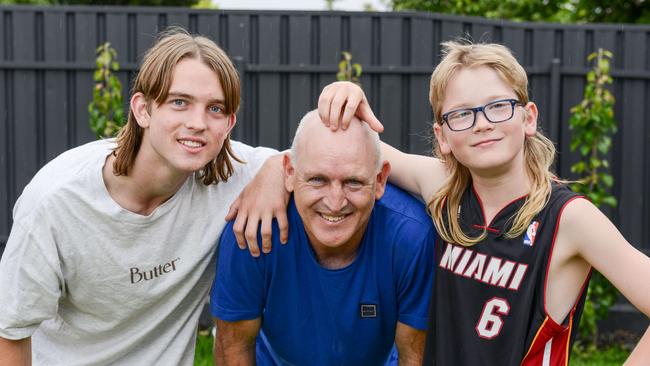 Want a mullet too Dad? Max, 16, and Harry, 11, Downs have some fun with Dad Jamie about his locks, or lack of them. Picture: Brenton Edwards