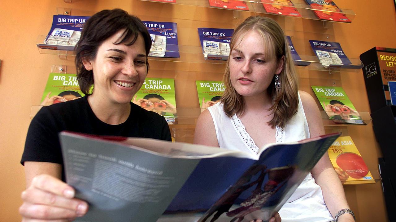 Two young Australians planning their next trip at an STA Travel store in 2003. Picture: Sam Ruttyn
