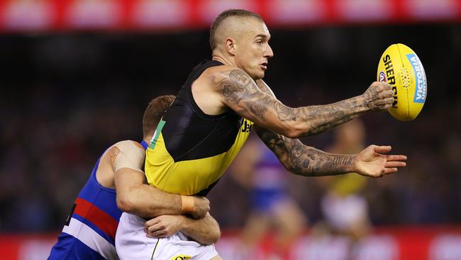 Dustin Martin of the Tigers gets tackled by Hayden Crozier of the Bulldogs.