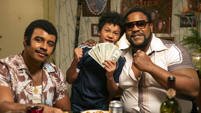 Joseph Lee Anderson as Rocky Johnson, Adrian Groulx as Dwayne and Nate Jackson as Junkyard Dog in a scene from Young Rock. Picture: Mark Taylor/NBC