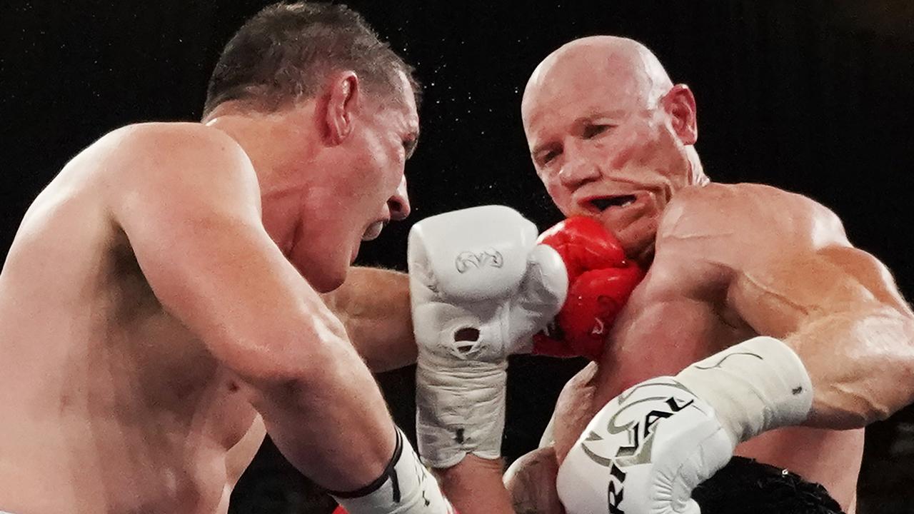 Paul Gallen lands a blow on former AFL player Barry Hall.