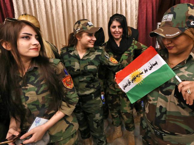 Female members of a Kurdish Peshmerga battalion queue inside a polling station as they wait to cast their vote in the Kurdish independence referendum in Arbil, on September 25. Picture: AFP / SAFIN HAMED