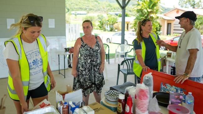 Renae Amadio, Kerri Mason, Rennae Brant and John Mason on deck at Kamerunga Villas on Thursday helping flood victims. Picture: Nuno Avendano