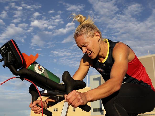 Crows star Erin Phillips on the stationary bike during a gruelling AFLW pre-season session at West Lakes in December 2018. Picture: Sarah Reed