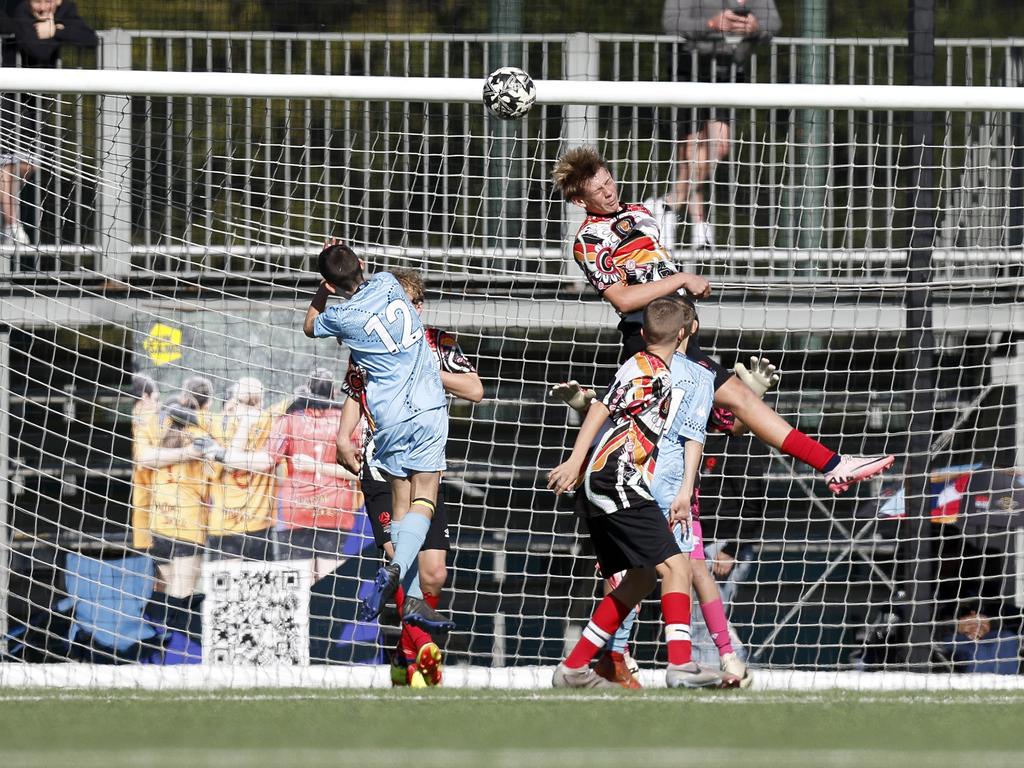 Lachlan Blayden gets up high, U14 Boys NAIDOC Cup at Lake Macquarie Regional Football Facility. Picture: Michael Gorton