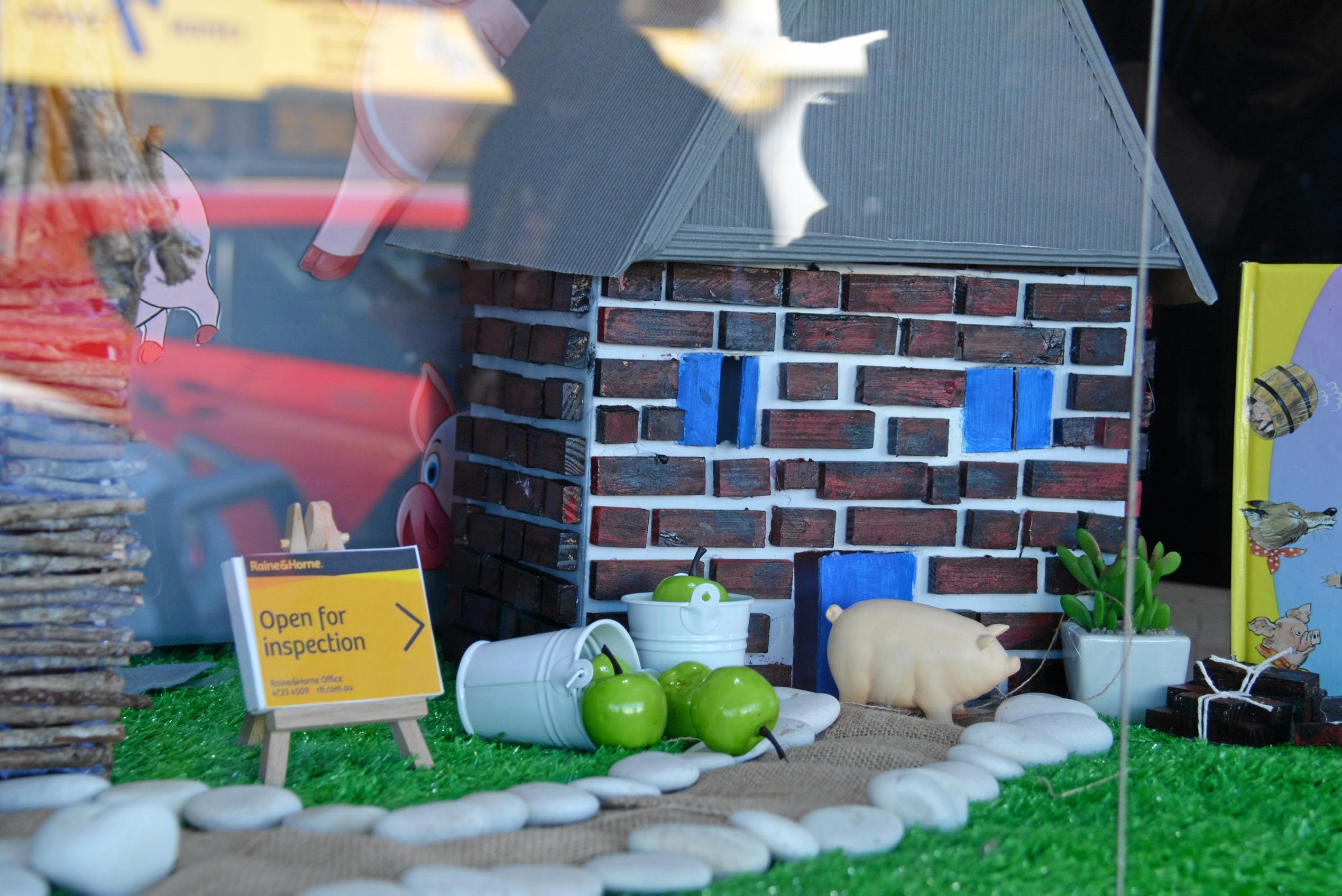 FOR SALE: Raine&Horne Kingaroy assisted the three little pigs with selling their houses in their window display from the BaconFest street window competition. Picture: Jessica McGrath