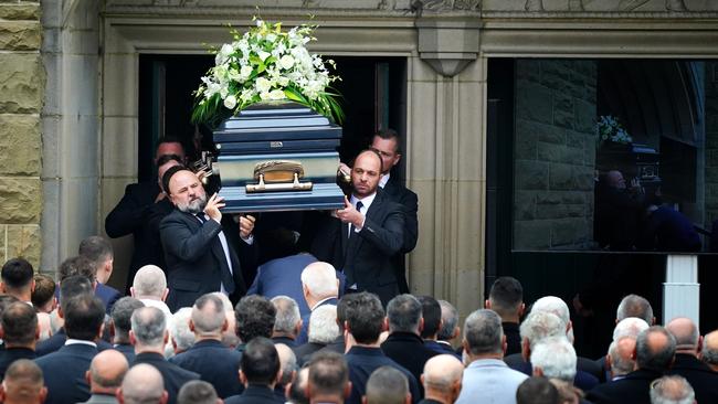 His coffin was carried out by loved ones as the huge crowd of mourners stood by. Picture: NCA NewsWire