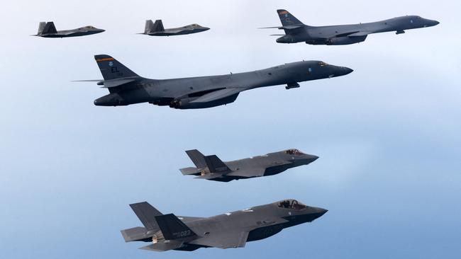 US Air Force B-1B strategic bombers (C), South Korean Air Force F-35 fighter jets (bottom) and US Air Force F-22 stealth fighter jets flying over the Yellow Sea during a joint air drill. Picture: AFP.