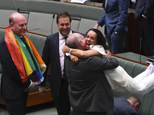 Liberal MP WarrenEntsch lifts up Labor MP Linda Burney as they celebrate the passing of the Marriage Amendment Bill in the House of Representatives at Parliament House in Canberra, Thursday, December 7, 2017. (AAP Image/Lukas Coch) NO ARCHIVING