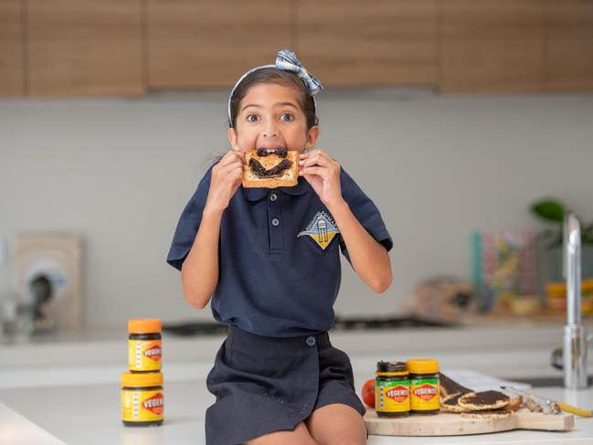 Zara, 8, tuckes into some gluten-free Vegemite. Picture: Jason Edwards