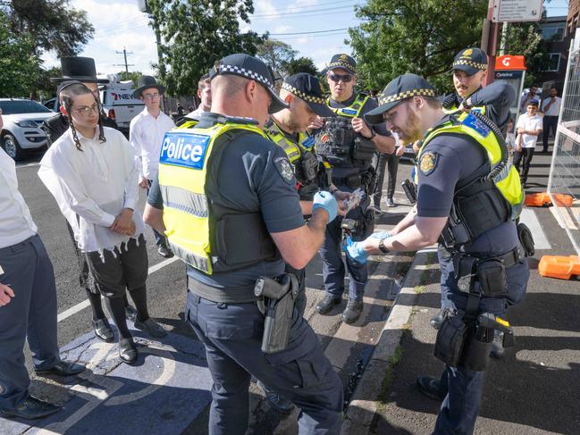 Acting Inspector Brendan Summers inspecting the bullet. Picture: Tony Gough