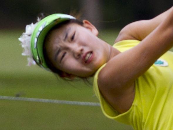 This Aug. 5, 2013 photo provided by the USGA shows Lucy Li hitting a tee shot on the 18th hole during the U.S. Women's Amateur Championship in Charleston, S.C. Li has become the youngest player to qualify for the U.S. Women's Open by winning the sectional qualifier at Half Moon Bay in California. The 11-year-old Li shot rounds of 74-68 on the par-72 Old Course on Monday, May 19, 2014. (AP Photo/USGA, Steve Gibbons)