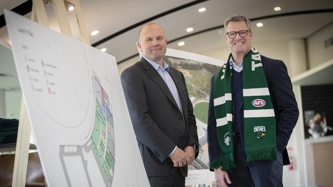 Waypoint Managing Director Chris Dare and Tasmania Football Club Chair Grant O'Brien with photos of Brisbane Lions and Sydney Swans High Performance Centre's which will be used in the Tasmania design. Picture: Chris Kidd