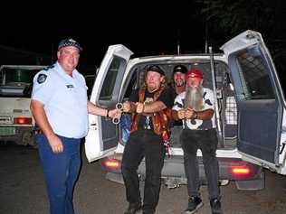 ON THE JOB: Andrew Gale "arresting” country rock group The Wolverines at the Dirt and Dust festival during his time as a cop at Julia Creek. Picture: Contributed