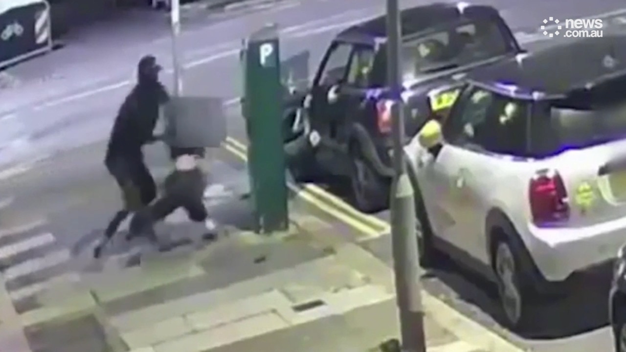Chilling moment balaclava-wearing man snatches woman from street