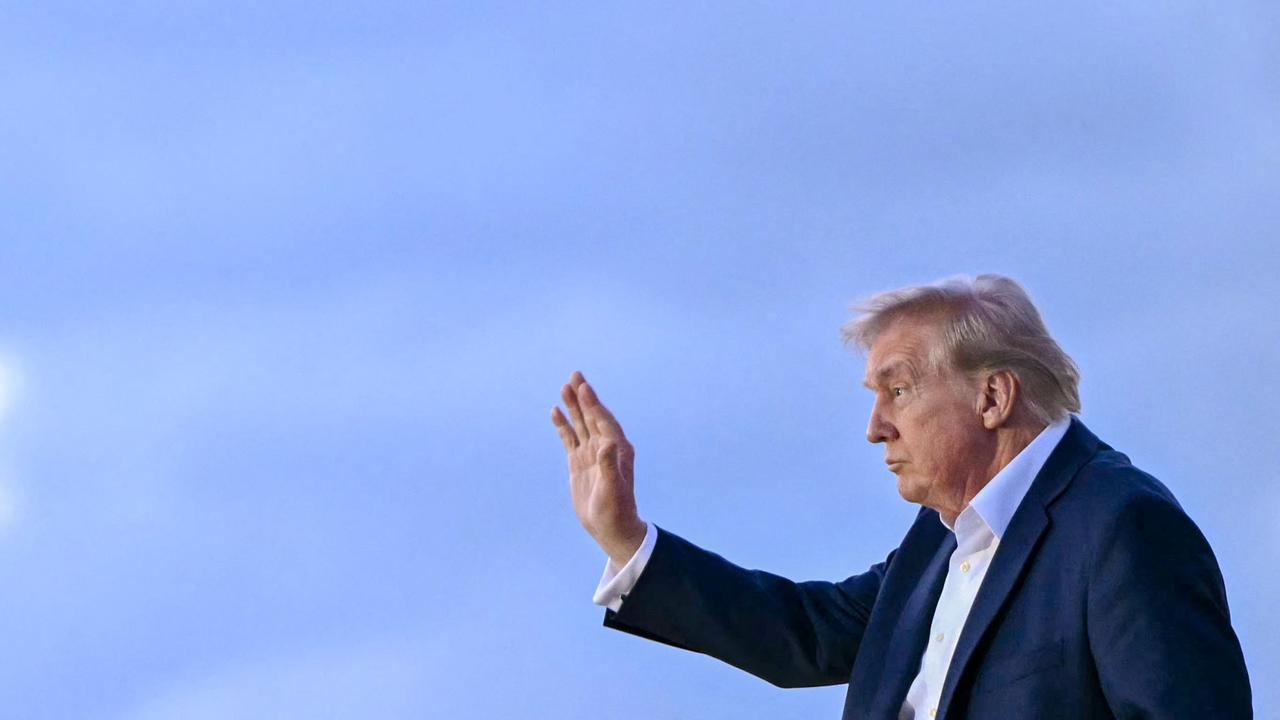 Donald Trump waves as he disembarks Air Force One. Picture: Mandel Ngan/AFP