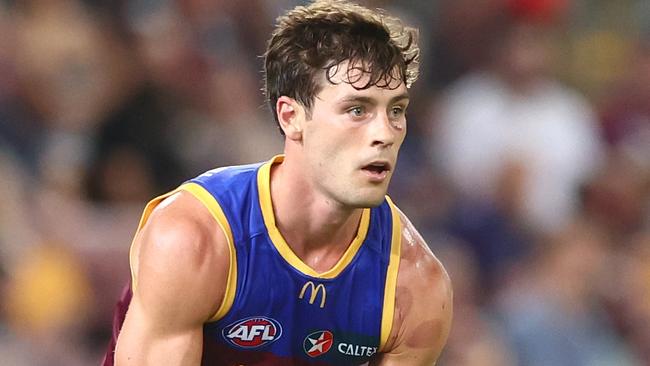 BRISBANE, AUSTRALIA - MARCH 24: Josh Dunkley of the Lions handballs during the round two AFL match between Brisbane Lions and Melbourne Demons at The Gabba, on March 24, 2023, in Brisbane, Australia. (Photo by Chris Hyde/Getty Images)