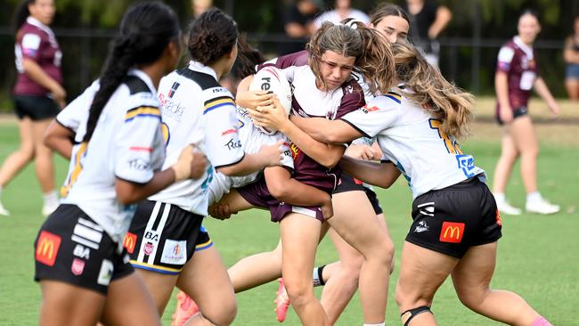 Burleigh Bears Isabella Brown is tackled by Souths Logan girls in the U17s. Picture, John Gass