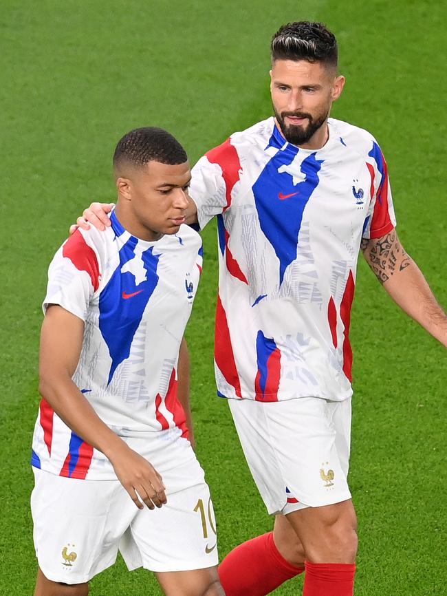 Kylian Mbappe and Olivier Giroud warm up.