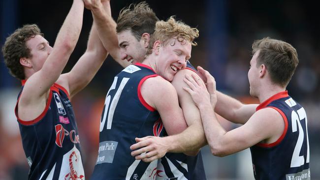 Tim Smith gets hugged by Clayton Oliver. Picture: Michael Klein