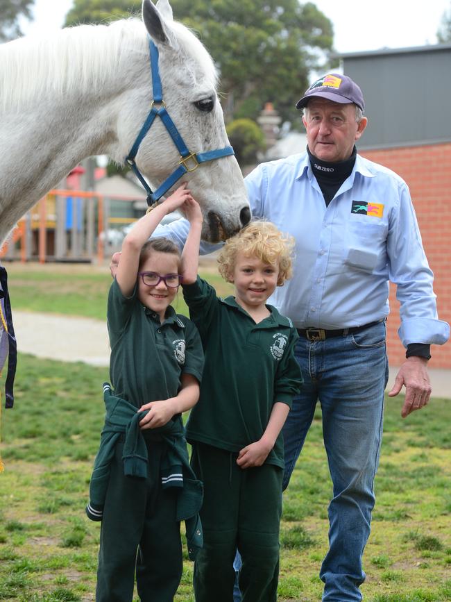 Melbourne Cup winning horse Sub Zero, with trainer Graham Salisbury, visits children Frankie Willson and Oscar Kattwinkle at South Geelong Primary School. Picture: Mitch Bear.