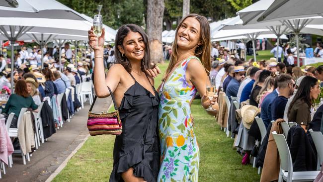 Dareen Mohd and Ruby Collins say “cheers” to the World’s Longest Lunch. Picture: Jake Nowakowski