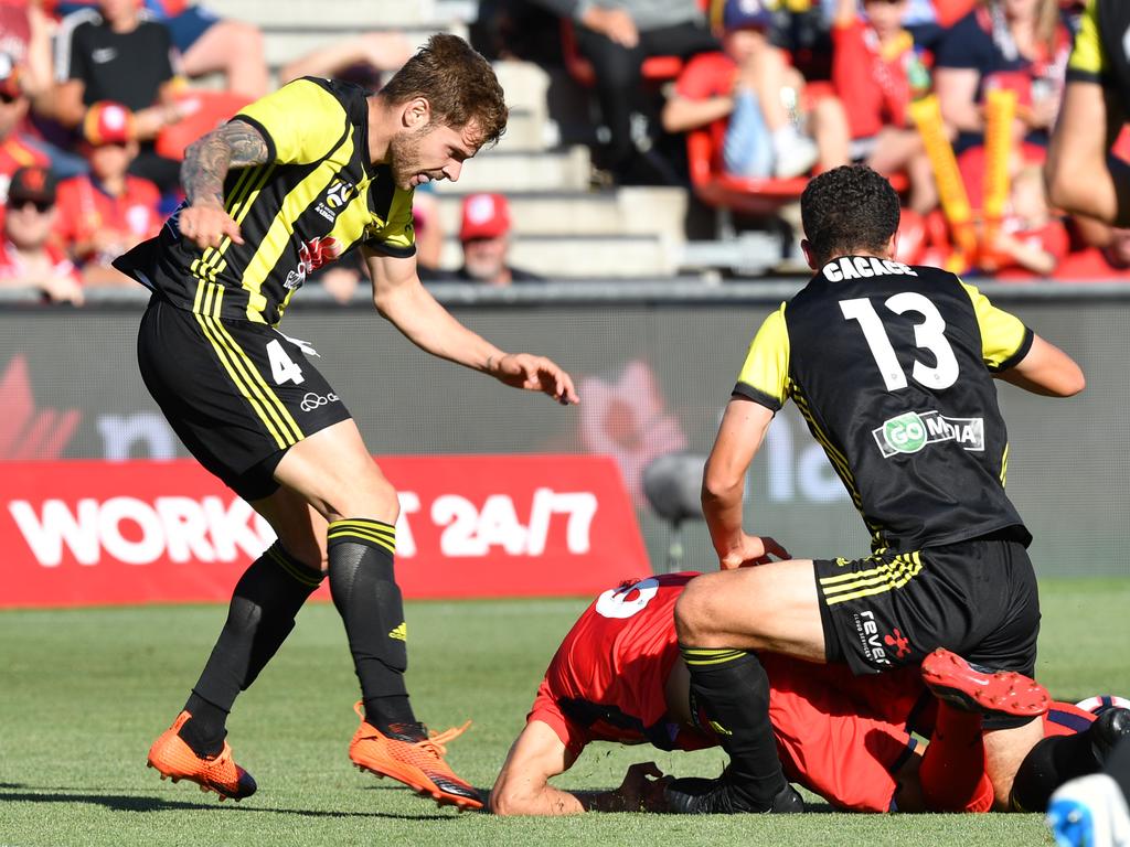 Armando Sosa Pena (Mandi) of the Phoenix appears to kick Vince Lia of United during the Round 11 A-League match at Coopers Stadium. Picture: AAP Image/David Mariuz