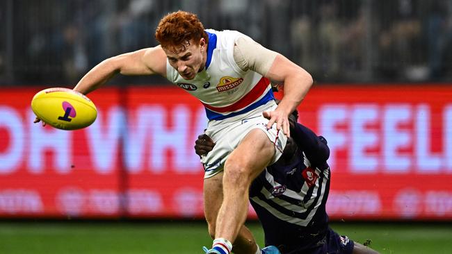 Ed Richards is run down by Michael Frederick. Picture: Daniel Carson/AFL Photos via Getty Images