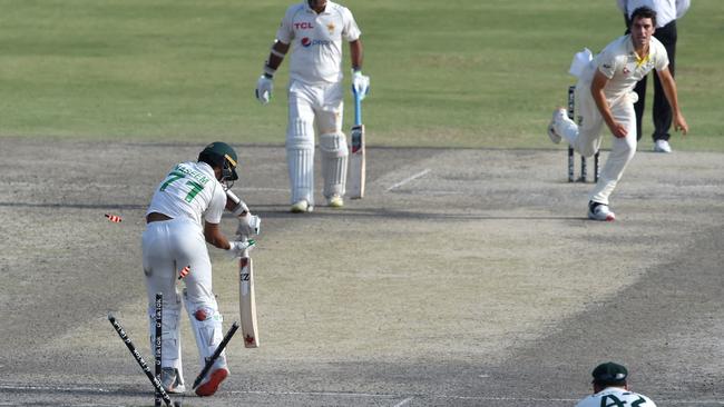 Pat Cummins skittles the stumps to dismiss Naseem Shah. Picture: Arif Ali/AFP