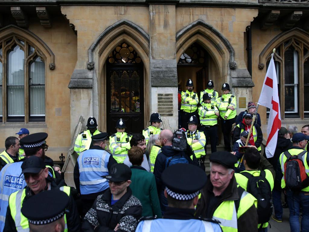 Police officers on duty as demonstrators wearing yellow vests protest inside and outside of the offices of Britain's Attorney-General, in London. Picture: AFP
