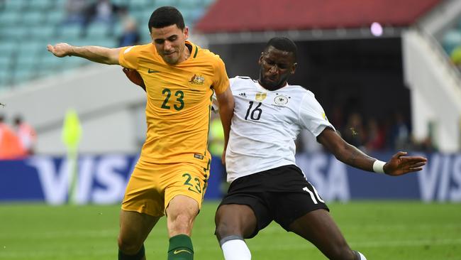 Australian forward Tom Rogic is tackled by Germany defender Antonio Ruediger.