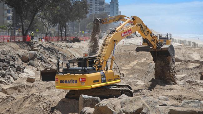 Work continues on the boulder wall at Surfers Paradise in preparation for the giant swell expected from the cyclone off the coast. Picture Glenn Hampson