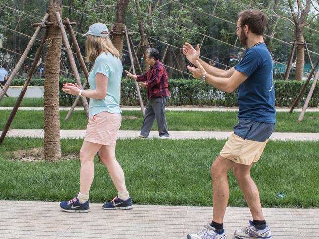 Pianist Suzanne Powell and production co-ordinator Brendan Taylor doing tai chi in a Beijing park. Pic: Daniela Testa.