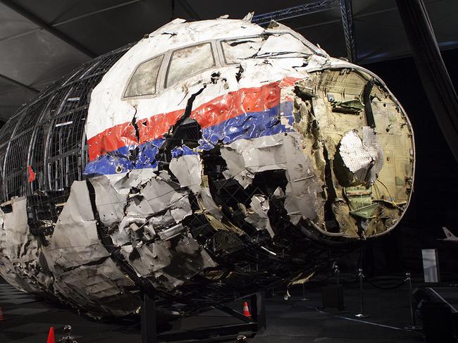 A supplied image obtained Wednesday, Oct. 14, 2015 of a reconstructed section of the Malaysia Airlines plane that was downed by a missile over Ukraine, killing 298 people at the Gilze-Rijen Air Force Base, the Netherlands on Wednesday. Parts of the cockpit and business class were reconstructed from wreckage retrieved from Ukraine and brought to the Netherlands where the crash investigation was based. (AAP Image/Dutch Safety Board) NO ARCHIVING, EDITORIAL USE ONLY