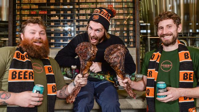 Pro skater Beau Hinge, centre, with tomahawk steaks held by Gus Love and Jack Winfield from Lovefield Catering for the 2021 Adelaide Beer and BBQ festival. Picture: Brenton Edwards