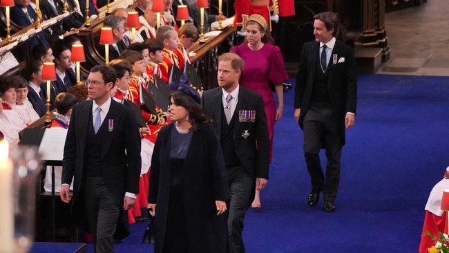 Prince Harry made small talk with Princess Beatrice and Eugenie’s husbands before entering alone. Picture: Aaron Chown / POOL / AFP