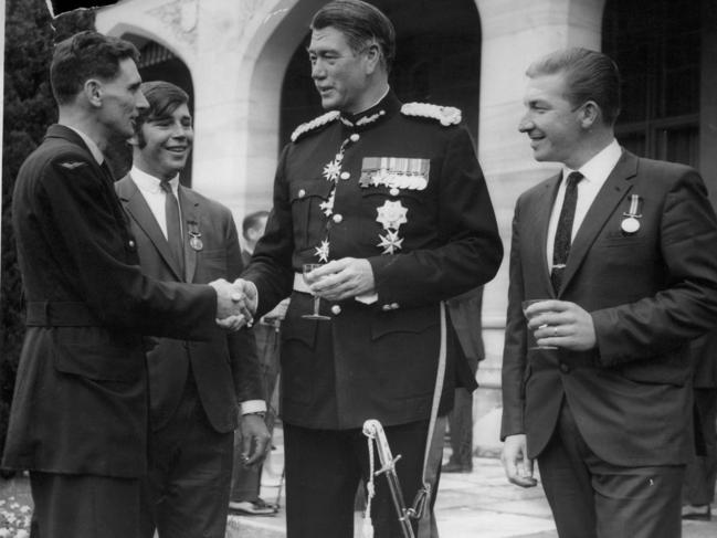 Aircraftman Kevin Wickerson, Private Richard Norden and Petty Officer William Young congratulated by the then Governor of NSW, Sir Roden Cutler