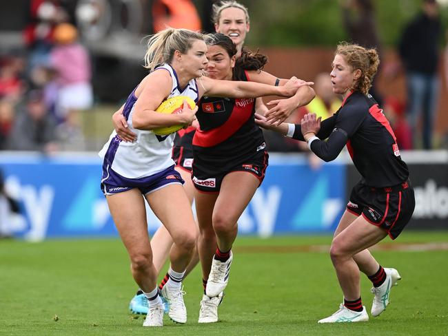 Hayley Miller of the Dockers fends off a tackle by Amy Gaylor at Windy Hill in Round 1. Picture: Quinn Rooney/Getty Images.