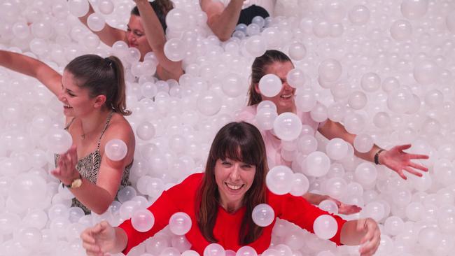 People play at The Cutaway in Barangaroo, as part of the Sydney Festival. Tina Walsberger (red dress) enjoying a swim. Pic Jenny Evans