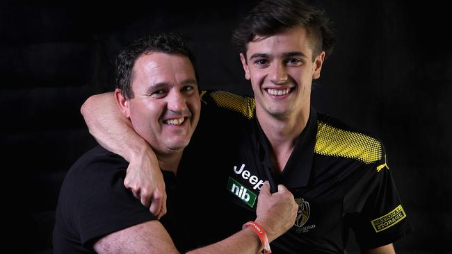 Former Richmond star Chris Naish with his son and new Tiger, Patrick.