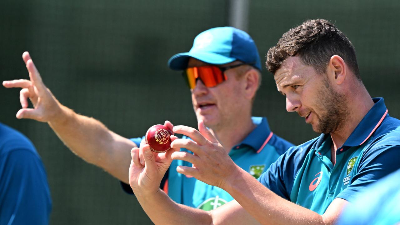 Australian bowler Josh Hazlewood (R) chats with coach Andrew McDonald (L) in the nets during a practice session at the Melbourne Cricket Ground (MCG).