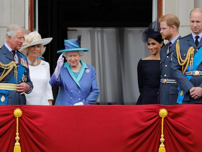 (FILES) In this file photo taken on July 10, 2018 (L-R) Britain's Sophie, Countess of Wessex, Britain's Prince Charles, Prince of Wales, Britain's Camilla, Duchess of Cornwall, Britain's Queen Elizabeth II, Britain's Meghan, Duchess of Sussex, Britain's Prince Harry, Duke of Sussex and Britain's Prince William, Duke of Cambridge stand on the balcony of Buckingham Palace to watch a military fly-past to mark the centenary of the Royal Air Force (RAF). - Britain's Prince Harry will relinquish his honorary military appointments and patronages after confirming to Queen Elizabeth II that he and wife Meghan Markle will not return as working royals, Buckingham Palace announced on February 19, 2021. (Photo by Tolga AKMEN / AFP)