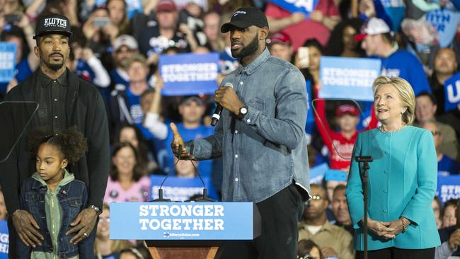Cleveland Cavaliers star LeBron James centre, speaks as his Cavalier teammate JR Smith, his daughter Demi and Democratic presidential candidate Hillary Clinton listen during a campaign rally.