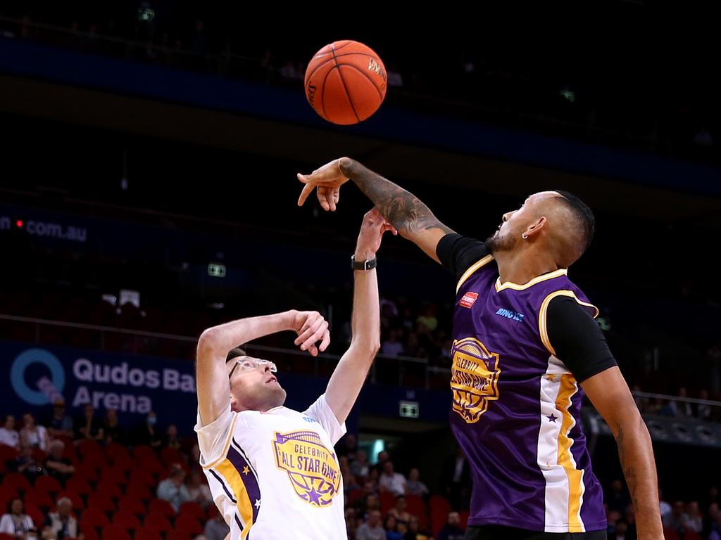 DENIED: Nick Kyrgios blocks NSW Premier Dominic Perrottet during the Sydney Kings Starlight Celebrity Game at Qudos Bank Arena last April. Photo: Jason McCawley/Getty Images.