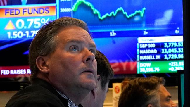 Traders work on the floor of the New York Stock Exchange as the US Federal Reserve announces a hike in interest rates. (Photo by TIMOTHY A. CLARY / AFP)