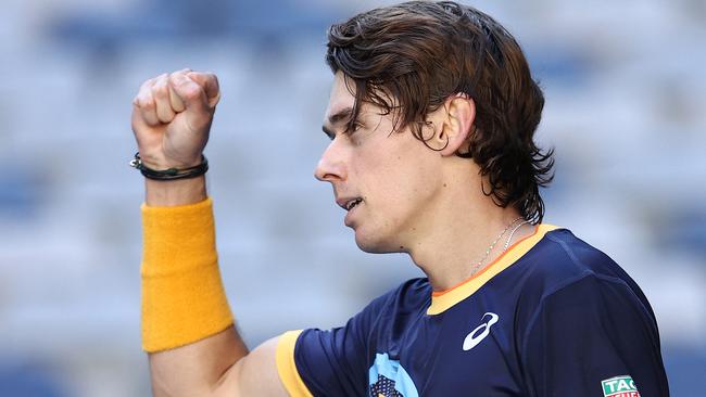 MELBOURNE, AUSTRALIA – FEBRUARY 09: Alex De Minaur of Australia celebrates after winning match point in his Men's Singles first round match against Tennys Sandgren of the United States during day two of the 2021 Australian Open at Melbourne Park on February 09, 2021 in Melbourne, Australia. (Photo by Darrian Traynor/Getty Images)