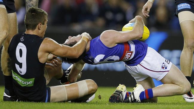 Toby McLean gets tackled high by Patrick Cripps. Picture: Michael Klein.