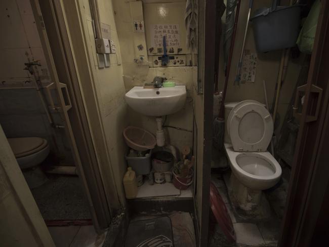 A set of grimy toilets and single sink shared by the coffin home's two dozen inhabitants, including a few single women, is located at a flat in Hong Kong. Picture: Kin Cheung/AP