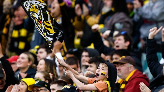 Richmond fans celebrate during the 2023 AFL Round 19 match between the Richmond Tigers and the Hawthorn Hawks at the Melbourne Cricket Ground on July 22, 2023. Picture: Dylan Burns/AFL Photos